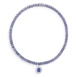 A TANZANITE AND DIAMOND PENDANT NECKLACE Composed of a continuous row of oval-shaped tanzanites,