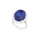 AN IMPORTANT TANZANITE AND DIAMOND CLUSTER RING The oval-shaped tanzanite weighing approximately