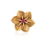 A RUBY AND DIAMOND BROOCH, CIRCA 1960 Of flowerhead design, the wirework petals set with a