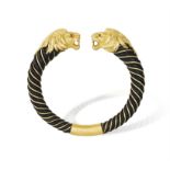 A RUBY AND GOLD BANGLE, BY GAY FRÈRES, CIRCA 1970 Each terminal modelled as a lion's head with