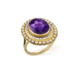 A VICTORIAN AMETHYST, ENAMEL AND SEED PEARL DRESS RING The oval-shaped amethyst within an white