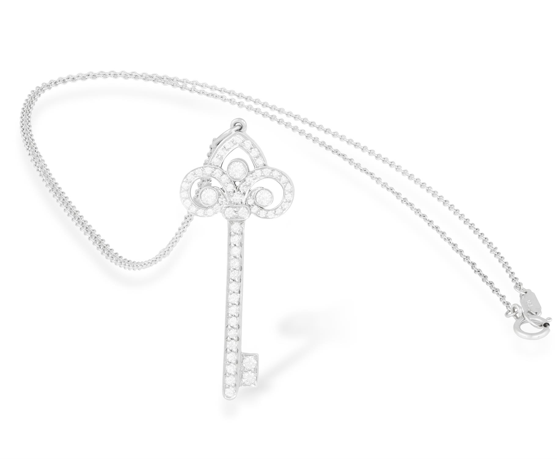 A DIAMOND 'FLEUR DE LIS' PENDANT ON CHAIN, BY TIFFANY & CO. Modelled as a stylised key,