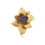 A SAPPHIRE BROOCH, BY VAN CLEEF & ARPELS, CIRCA 1960 Modelled as a stylised flowerhead centring