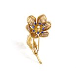 A SAPPHIRE AND DIAMOND BROOCH, FRENCH, CIRCA 1965 The brooch designed as a stylised flower with