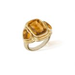 A CITRINE DRESS RING, BY REPOSSI The faceted top cabochon cushion-shaped citrine between two