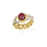 A RUBY AND DIAMOND DRESS RING The central oval-shaped ruby cabochon within collet-setting,