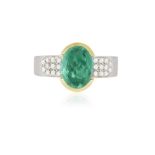 AN EMERALD AND DIAMOND DRESS RING The oval-shaped emerald weighing approximately 2.