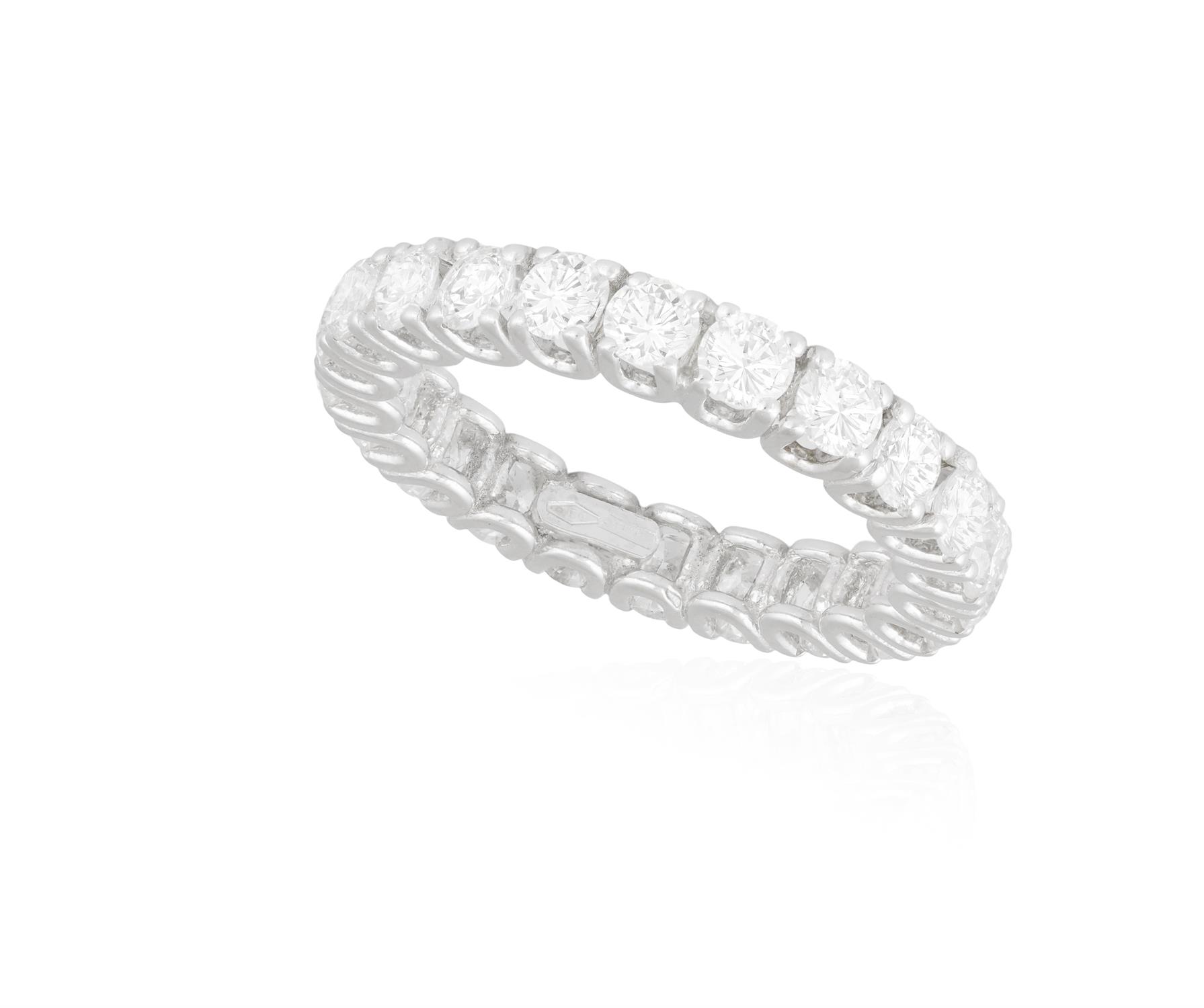 A DIAMOND ETERNITY RING The continuous row of brilliant-cut diamonds within claw-setting,