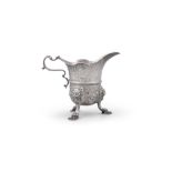 A GEORGIAN STYLE SILVER CREAMER With no apparent hallmarks, of helmet form with central girdle,