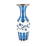 A LATE 19TH CENTURY BOHEMIAN BLUE GLASS WHITE ENAMEL OVERLAID VASE, of circular baluster form and