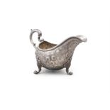 AN IRISH MID-GEORGIAN SILVER HELMET SHAPED SAUCEBOAT Apparently unmarked, gadrooned rim,