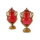 A PAIR OF FRENCH RUBY GLASS VASES AND COVERS c.1900, with gilt metal mounts, pomegranate finials
