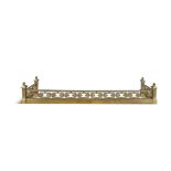 A VICTORIAN BRASS PIERCED FENDER with four column supports, surmounted by acorn finials and