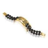 A DIAMOND AND EBONY BRACELET, composed of two leopards's profile roaring at each other,