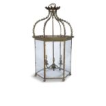 AN EDWARDIAN BRASS FRAMED HEXAGONAL HALL LANTERN With clear glass panel sides,