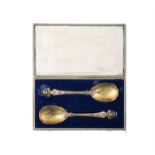 A PAIR OF VICTORIAN SILVER GILT SERVING SPOONS London c.1881, (c.7 troy ozs). 25cm long(cased)