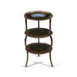 A FRENCH MAHOGANY GILT METAL AND PORCELAIN MOUNTED ETAGERE Of circular form, with three tiers