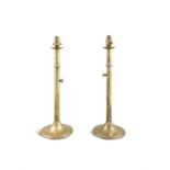 A PAIR OF BRASS SLIDE EJECTOR CANDLE STICKS CONVERTED TO TABLE LAMPS, the candlesticks early