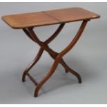 A Victorian mahogany coaching table with rounded corners to the rectangular fold-away top, & on