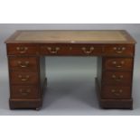 A Victorian mahogany pedestal desk, inset gilt-tooled tan leather to top & fitted with an