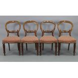 A set of four Victorian beech balloon-back dining chairs, each with pieced & carved rail to the open