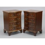 A pair of reproduction mahogany serpentine-front four-drawer bedside chests, on bracket feet, 19”