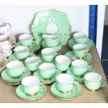 A Royal Paragon bone china forty-piece part tea service of green ground with gold rims, part w.a.f.