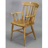 A beech lath-back elbow chair with a hard seat, & on turned legs with turned stretchers.