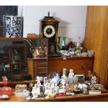 A battery-operated mantel clock; a pottery cylindrical stick stand; various decorative ornaments,