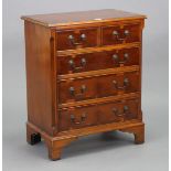 A reproduction yew wood small chest, fitted two short & three long graduated drawers with brass