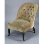 A Victorian buttoned-back nursing chair upholstered mushroom velour, & on short turned legs with