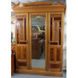 A Victorian satin walnut small three-section wardrobe with moulded cornice, enclosed by a