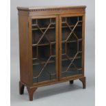 An Edwardian inlaid-mahogany china display cabinet with three adjustable shelves enclosed by a