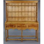 A PINE WELSH DRESSER in the 19th century-style, the upper part fitted three open shelves & with