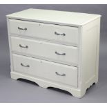 A white painted pine dwarf chest fitted three long graduated drawers with chrome-plated handles, &
