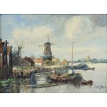 TINUS de JONGH (1885-1942) A harbour scene with figure in a vessel, a windmill & buildings beyond;