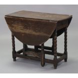 An 18th century oak gate-leg table with oval top, on bobbin-turned supports with plain stretchers,