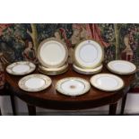 A collection of twenty various English porcelain dinner plates with raised gilt borders.