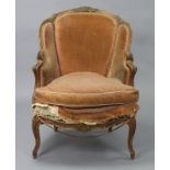 A Victorian carved mahogany frame easy chair with padded back & arms, upholstered peach coloured