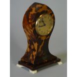 A late 19th/early 20th century tortoiseshell veneered timepiece of baluster form with painted arched