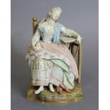 A Meissen figure of a lady asleep in a chair, one arm resting on a marble-top table, blue crossed
