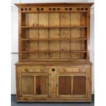 A 19th century pine Welsh dresser, with moulded cornice & three long shelves to the upper section,