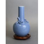 A Chinese porcelain bottle-shaped “dragon” vase with all-over lavender-blue glaze, decorated in