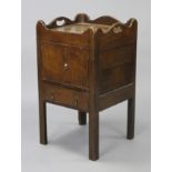 A late 18th century oak small tray-top bedside commode enclosed by a pair of panel doors, on