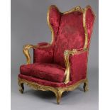 An 18th century style French carved giltwood frame fauteuil with tall padded wing back, open