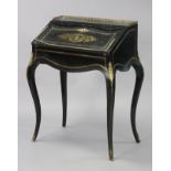 A 19th century French ebonised ladies’ writing desk, with sloping fall front inlaid with engraved