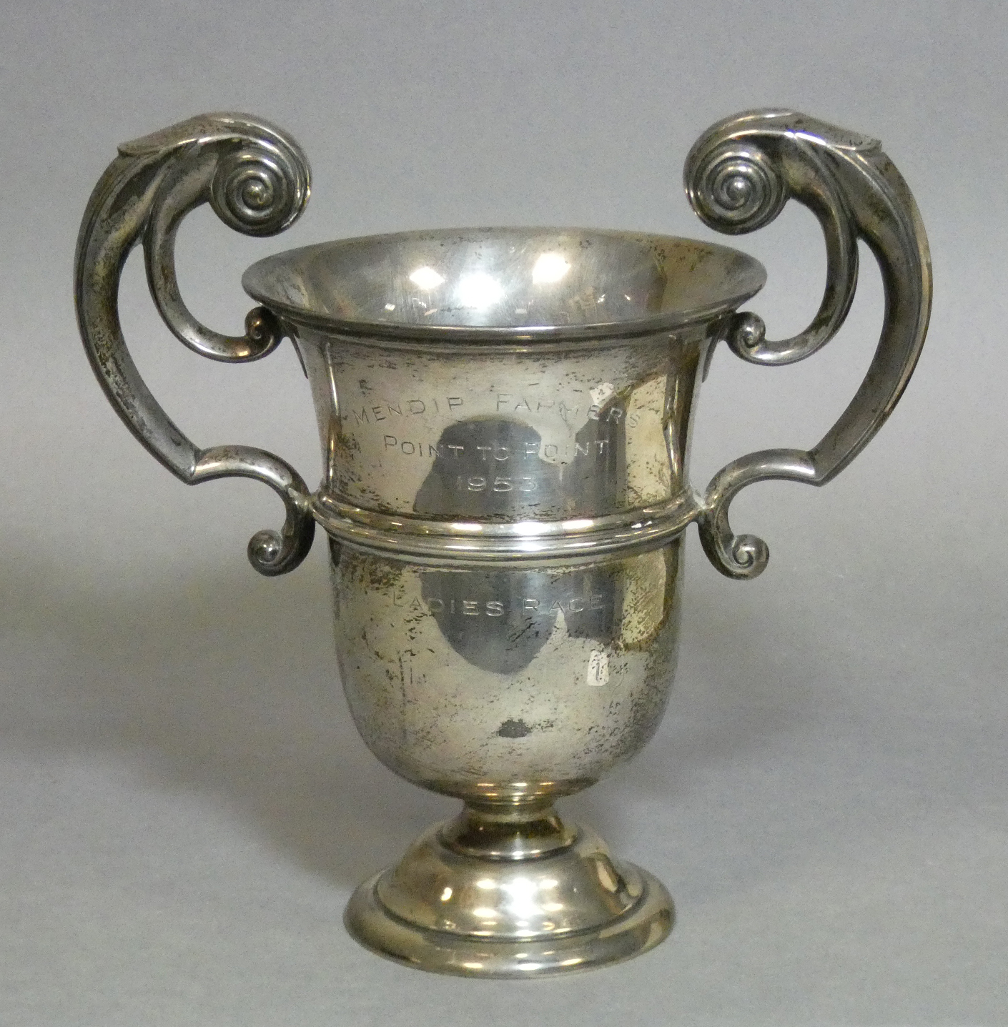 A George V silver trophy cup in the mid-Georgian style, with heavy scroll handles, engraved