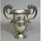 A George V silver trophy cup in the mid-Georgian style, with heavy scroll handles, engraved