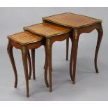 A nest of three parquetry inlaid occasional tables, of rectangular serpentine shape with gilt