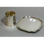 An Edwardian silver square card tray with rounded corners & raised moulded border, on four bun feet,